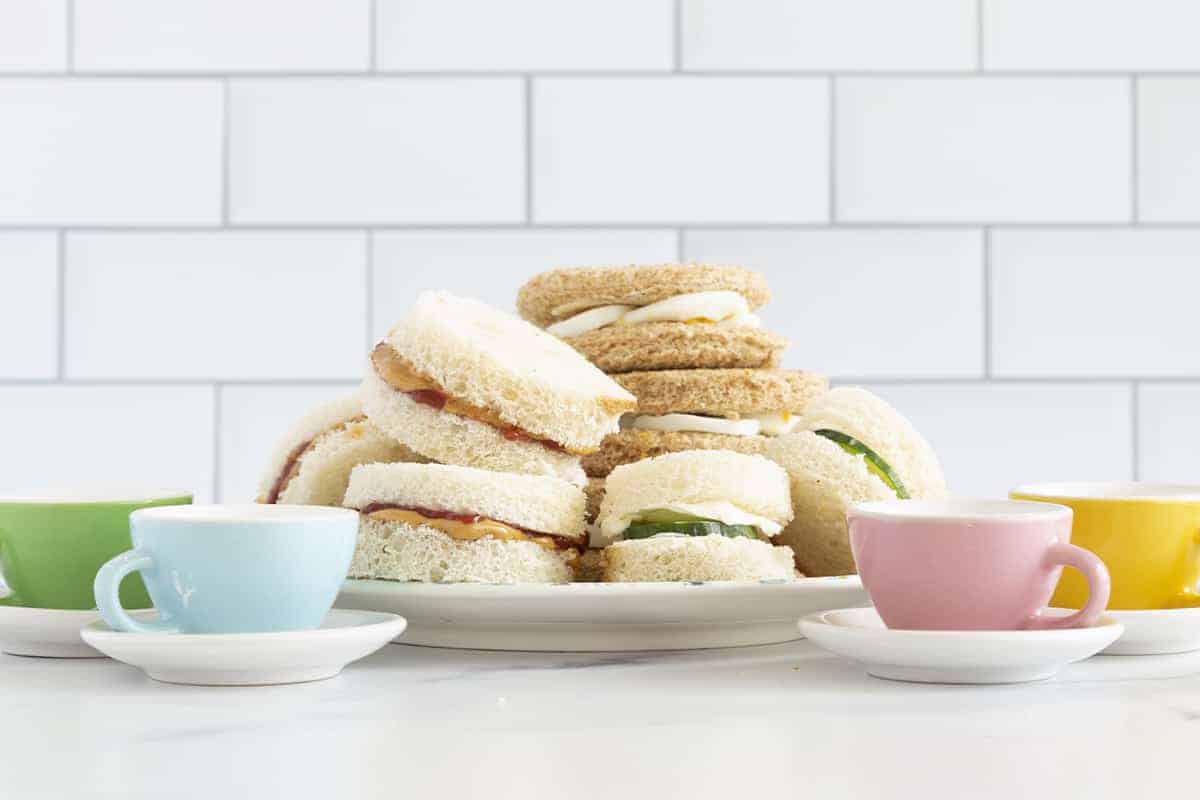 stack of tea sandwiches for kids on plate.