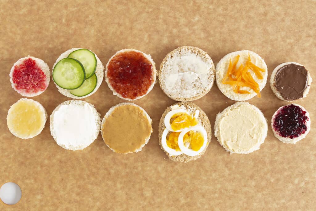 spreads on tea sandwiches on cutting board