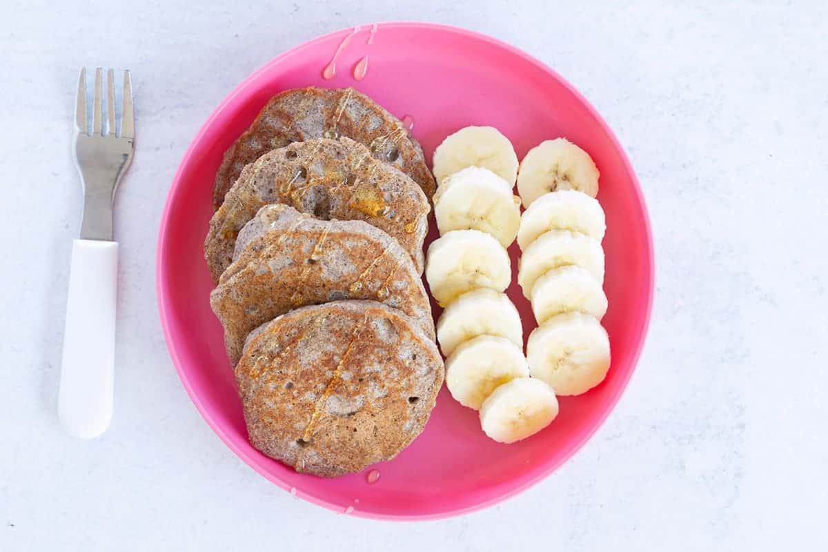 vegan banana pancakes on pink plate