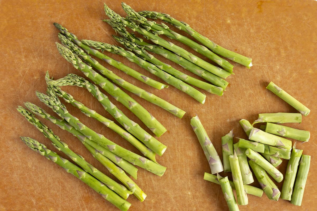cut pieces of asparagus on parchment paper for asparagus baby food