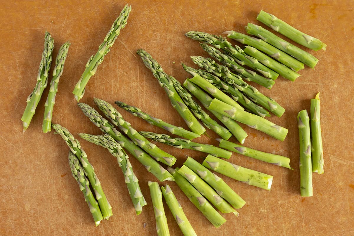 cut pieces of asparagus on parchment paper for asparagus baby food