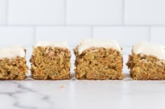 Frosted carrot cake cut into bars.