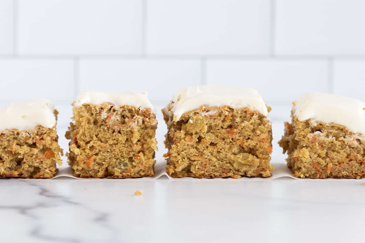 Frosted carrot cake cut into bars.