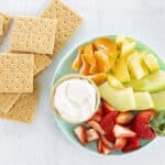 cottage cheese dip on plate with fruit and graham crackers