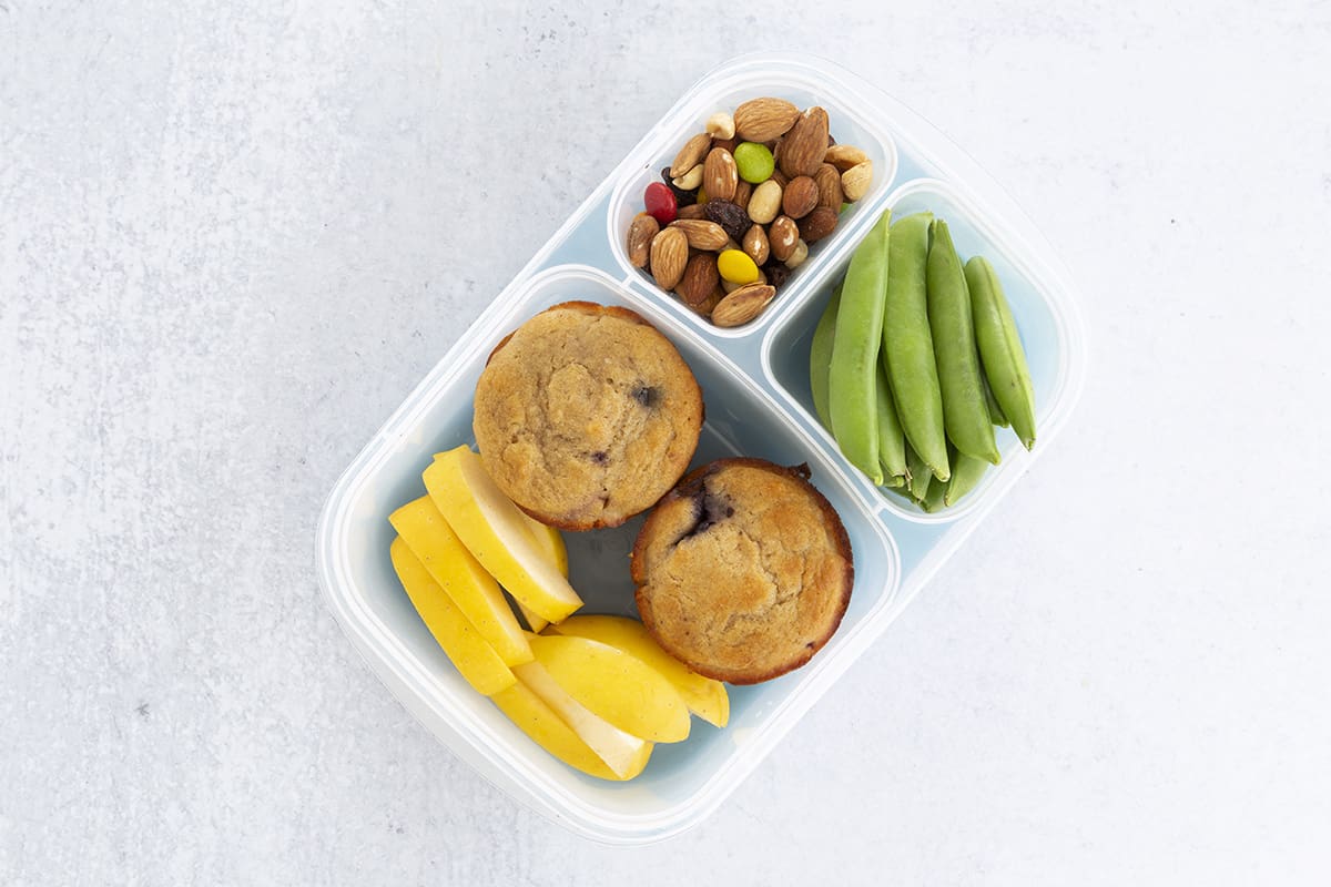 muffin lunch with snap peas, apples and trail mix in lunchbox