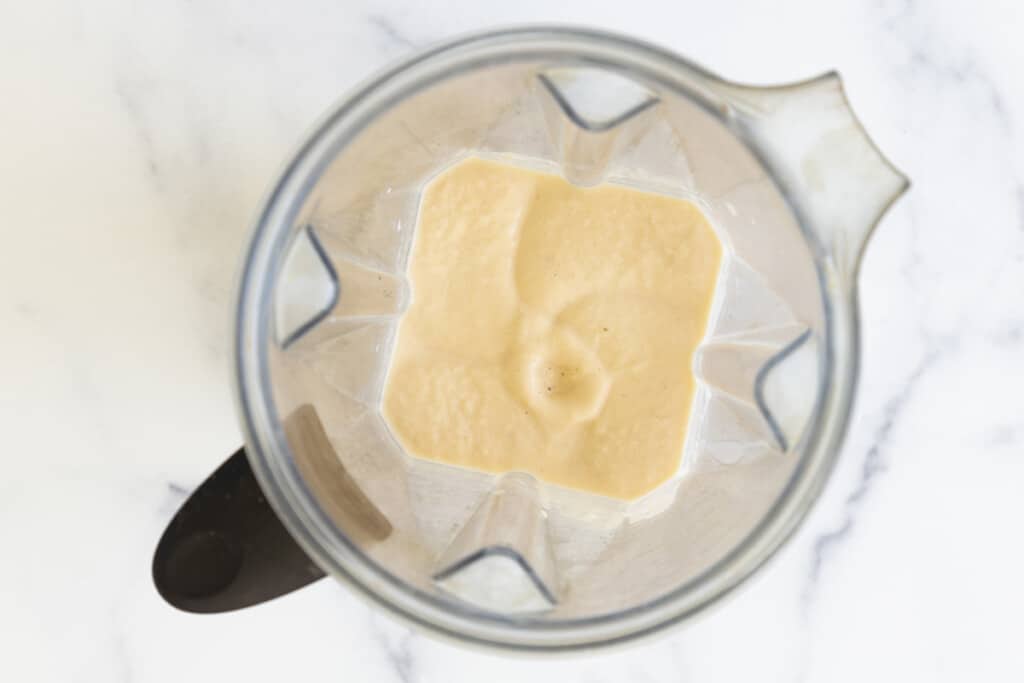 Ingredients blended in blender for peach smoothie