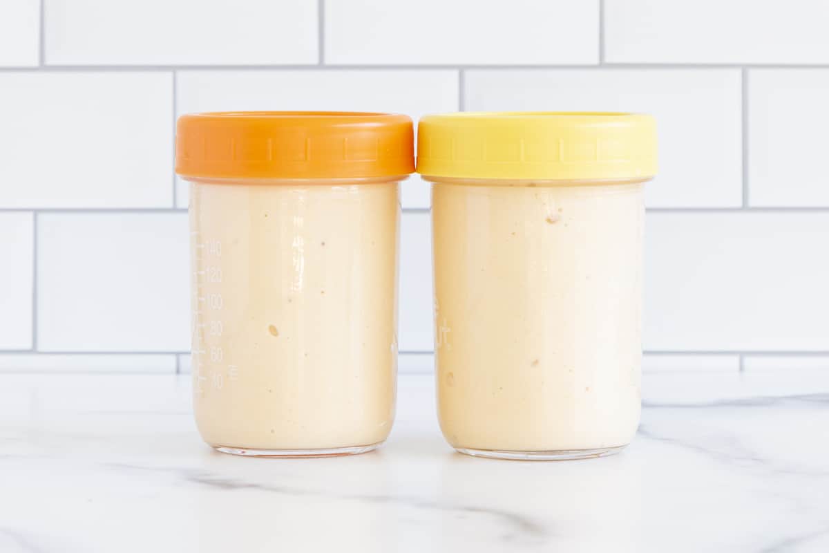 Peach smoothie in two containers with lids