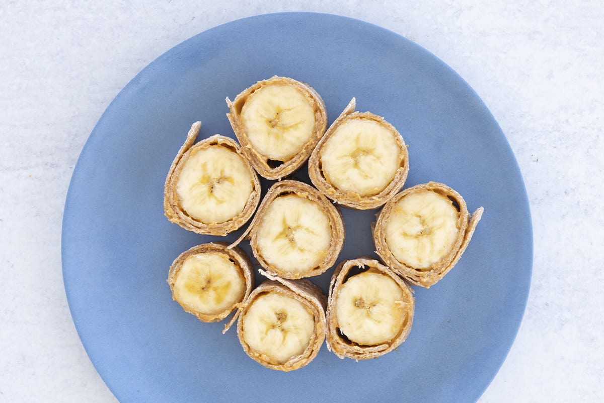 banana sushi rolls on blue plate