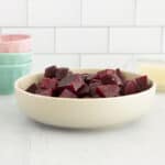 boiled beets in white bowl on countertop