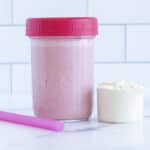 kids smoothie in jar with scoop of protein powder on counter.