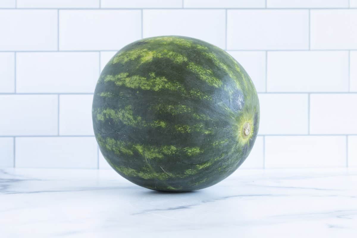 Whole watermelon for baby on white counter