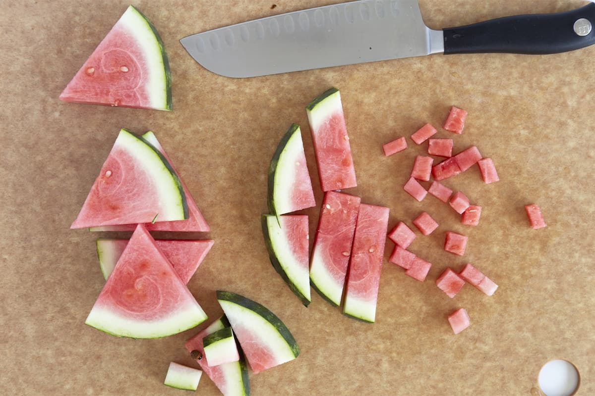 Watermelon cut in various shapes on parchment paper for baby food