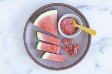 Watermelon for baby in various forms on grey plate