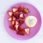 yogurt dip on plate with strawberries