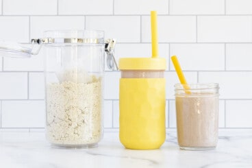 protein powder recipe next to yellow smoothie cup.