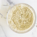 Homemade protein powder in glass bowl on white countertop
