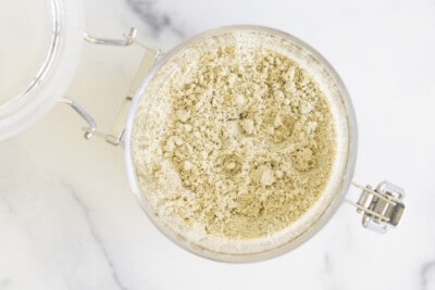 Homemade protein powder in glass bowl on white countertop