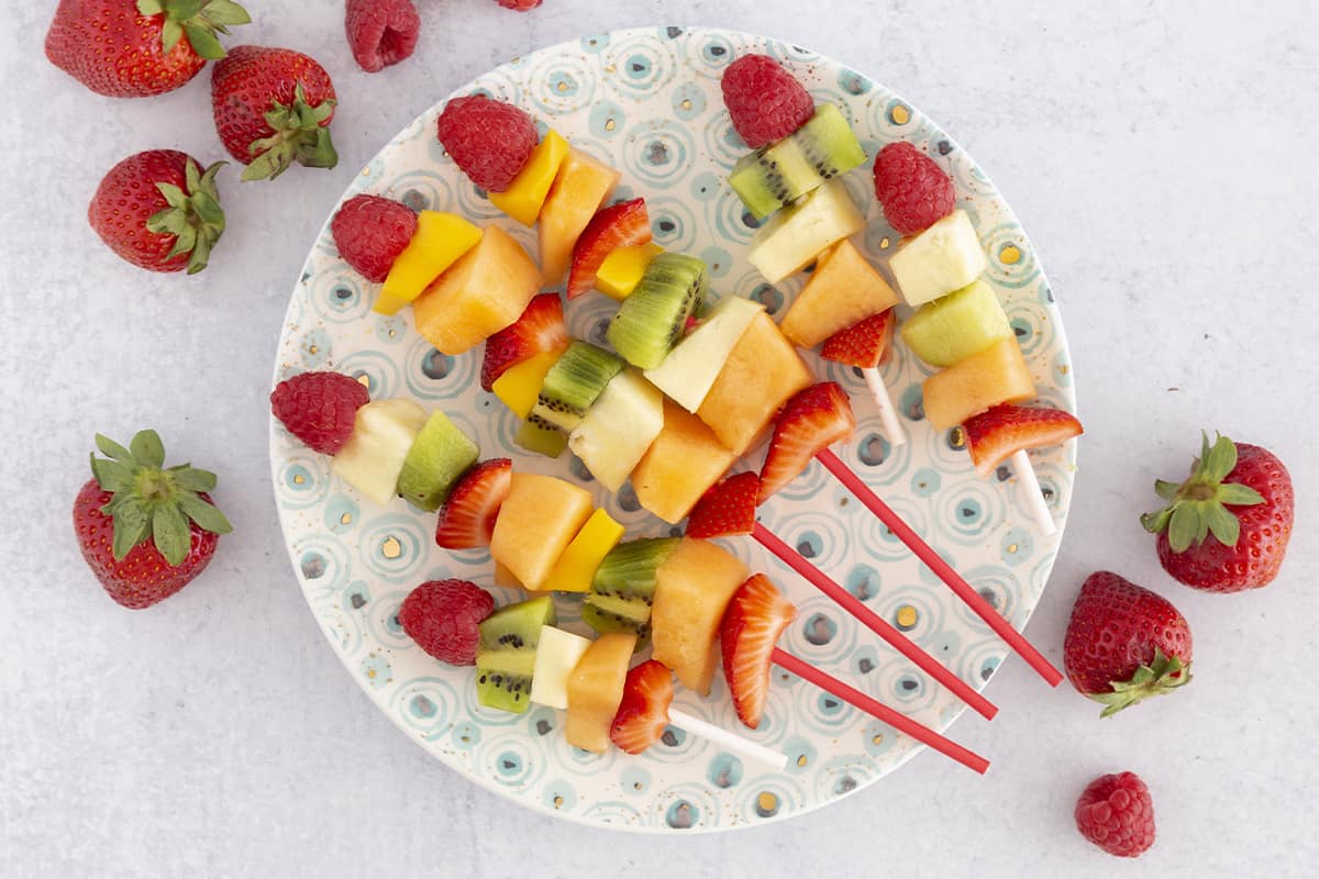 fruit sticks on polka dot plate.