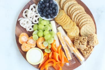 round wooden snack plate with snacks