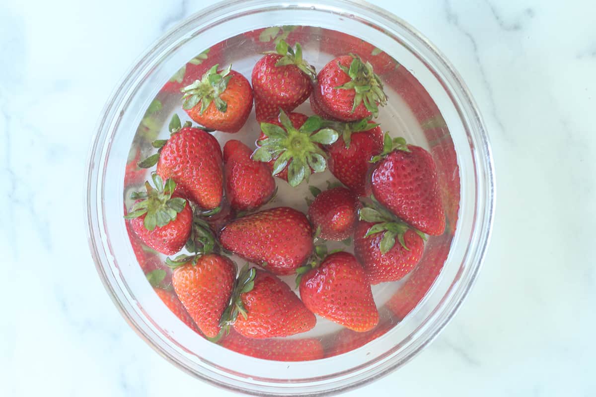strawberries washing in bowl of water and vinegar