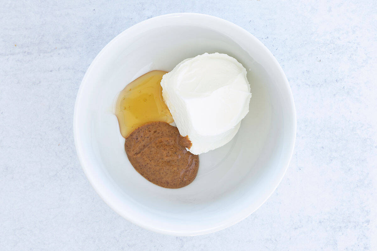 ingredients for yogurt dip in white bowl.