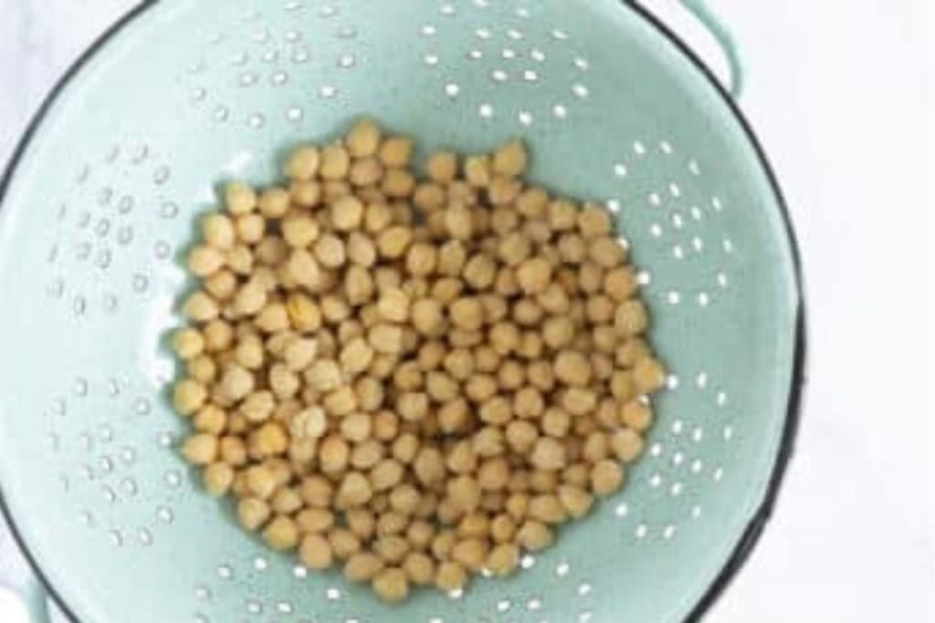 Chickpeas in strainer for quinoa salad.