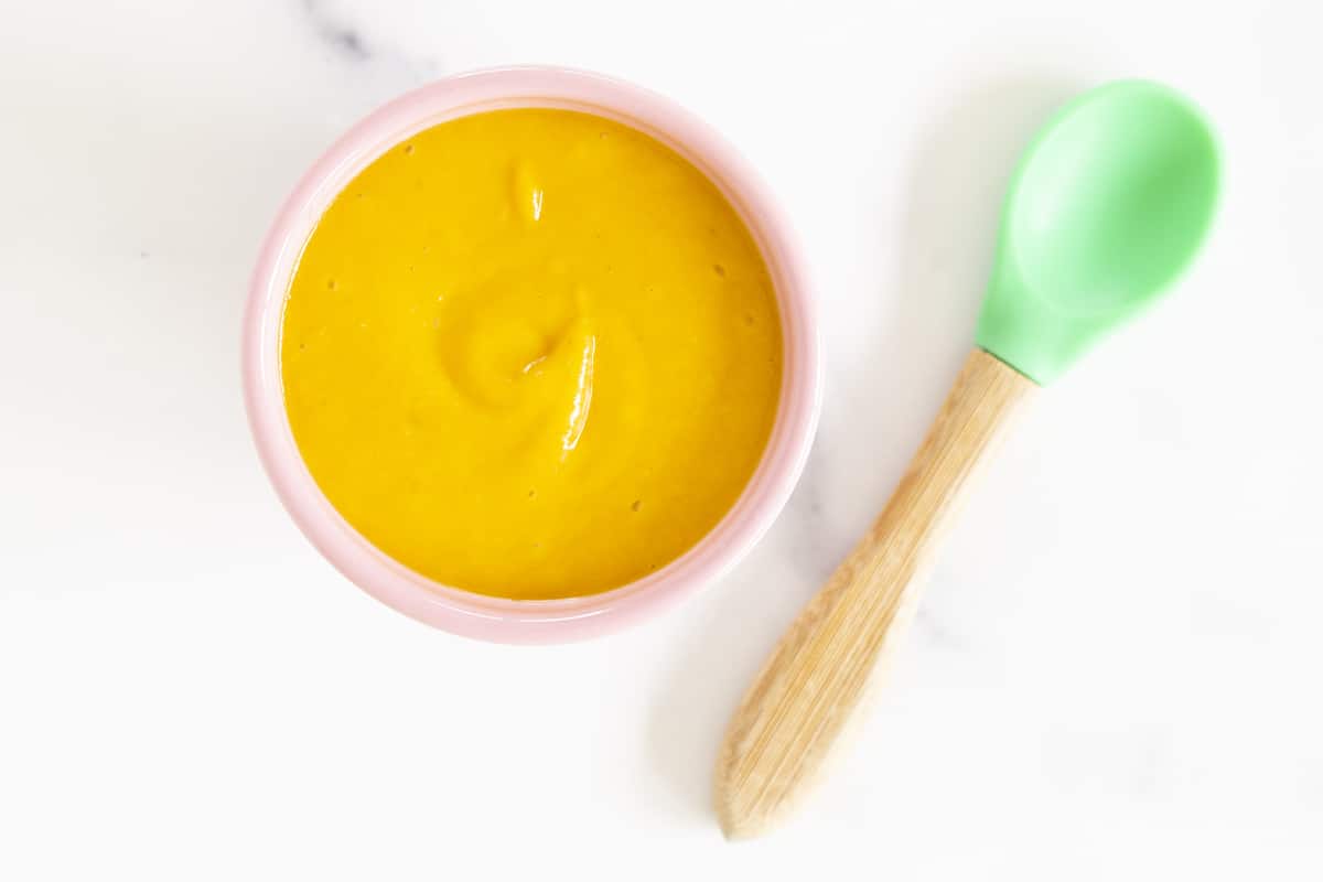 pureed apricot in bowl with spoon for apricot baby food