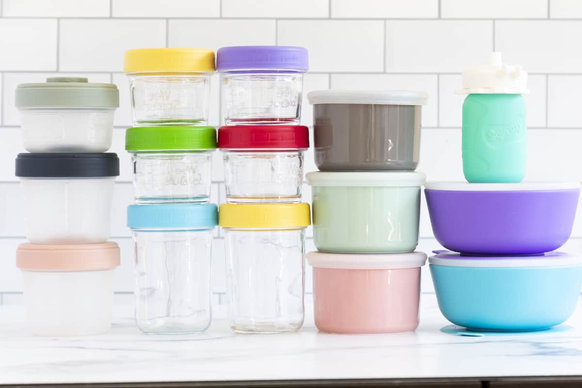 All different baby food storage containers all stacked on countertop.