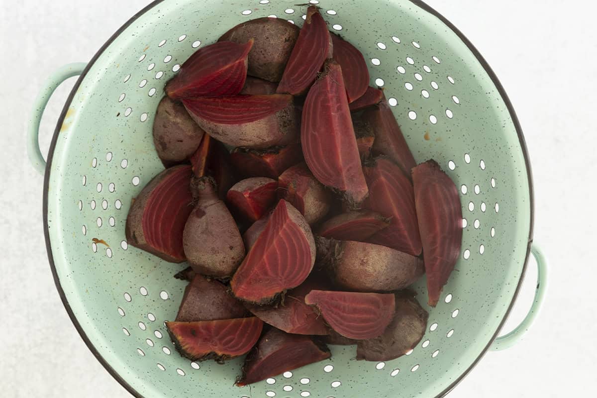 Boiled beets in strainer.