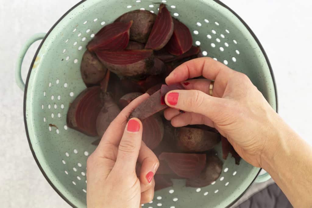 Hands holding boiled beet.