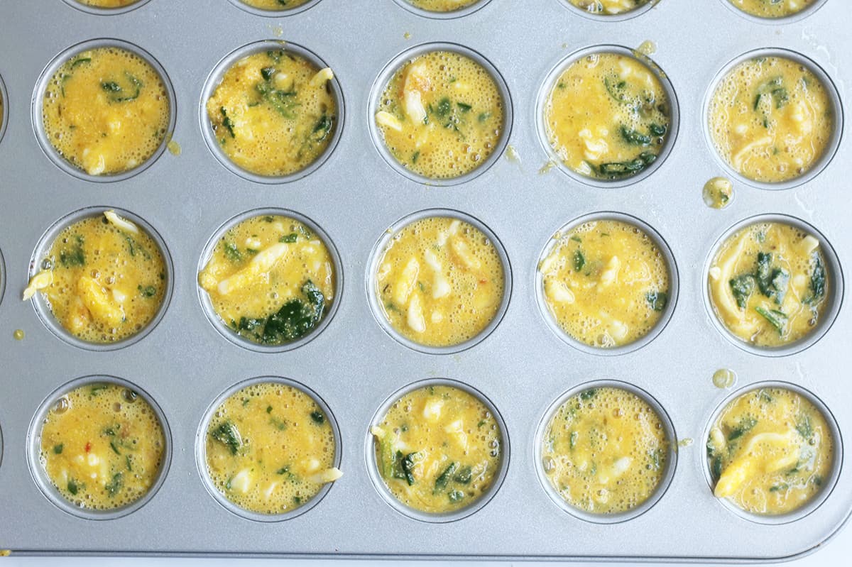 batter for spinach egg muffins in pan.