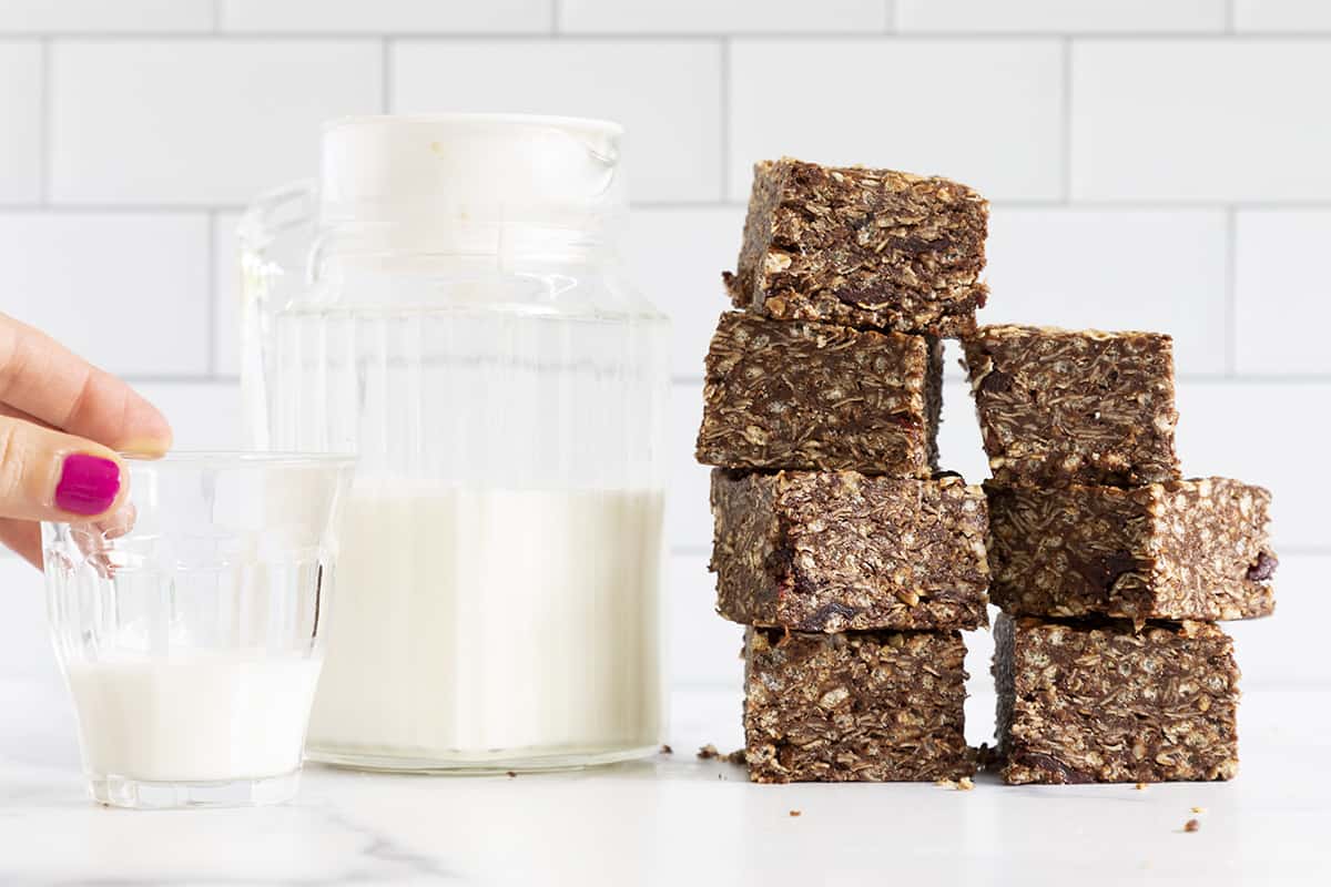 chocolate granola bars in stack with milk jug.