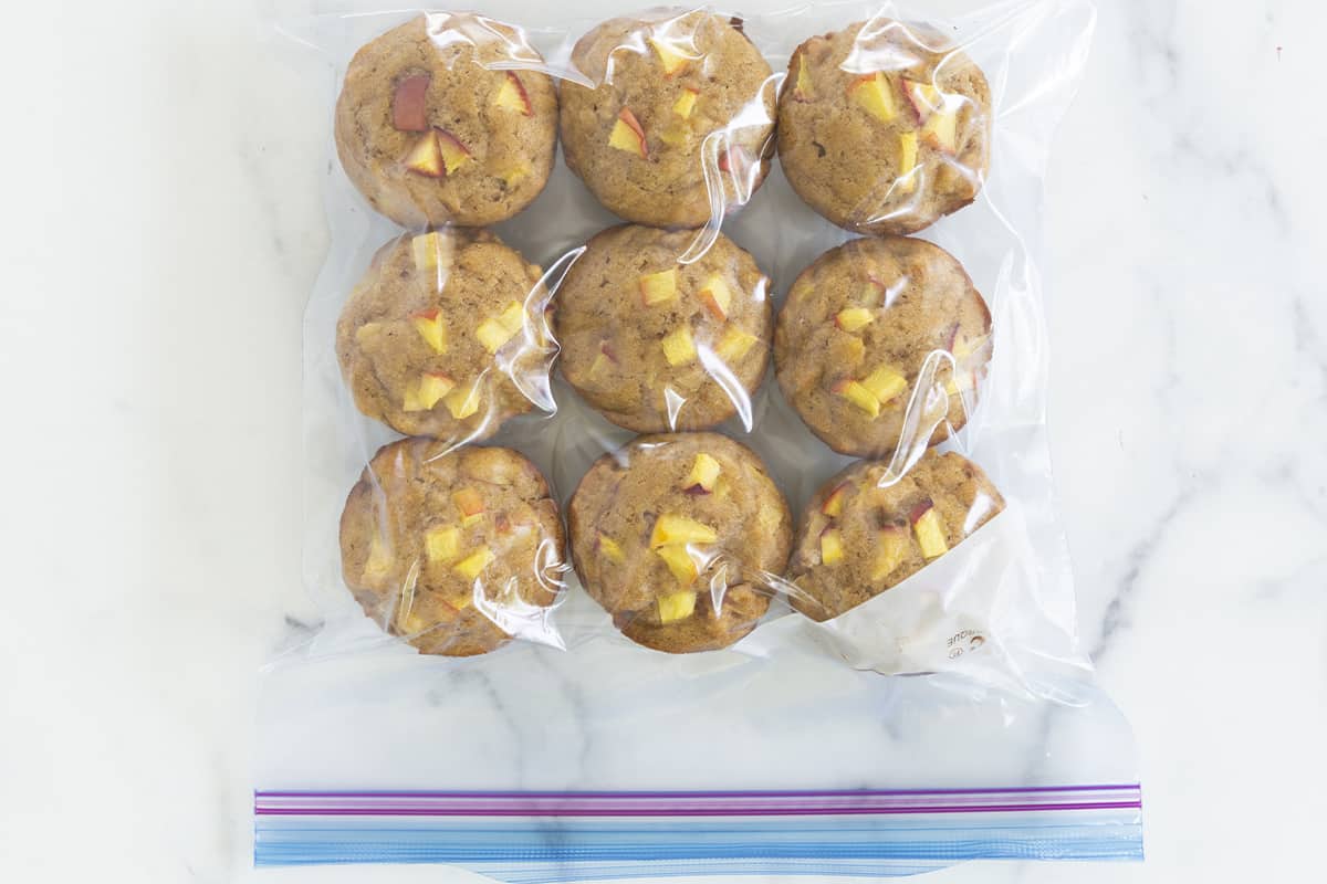 peach muffins in freezer bag on countertop.