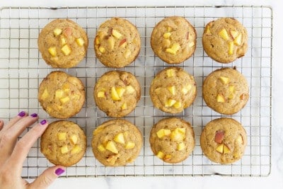 peach muffins on cooling rack