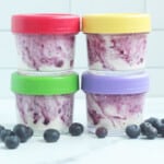 blueberry yogurt in four jars with lids, stacked