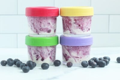 blueberry yogurt in four jars with lids, stacked