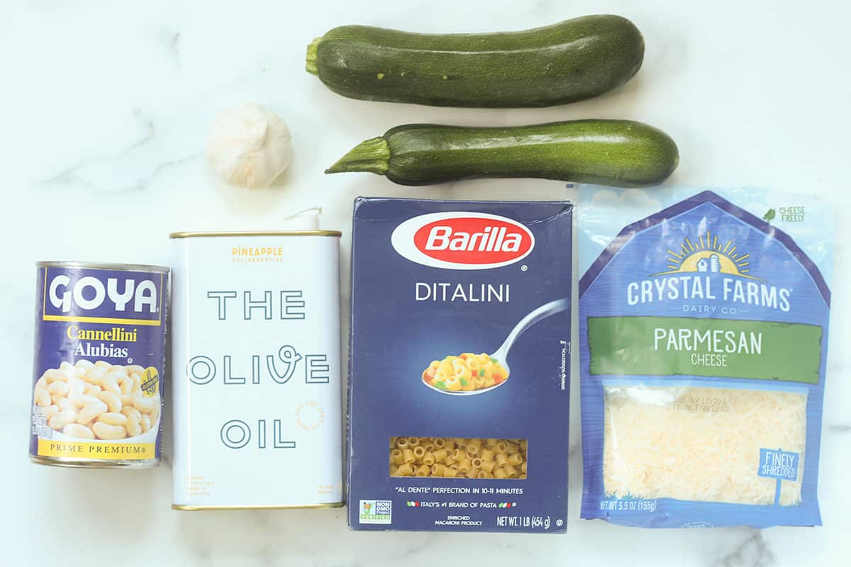Ingredients for zucchini pasta sauce on white countertop