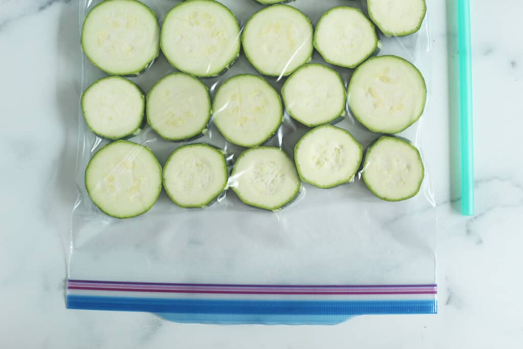 zucchini slices in zip top bag ready to freeze zucchini