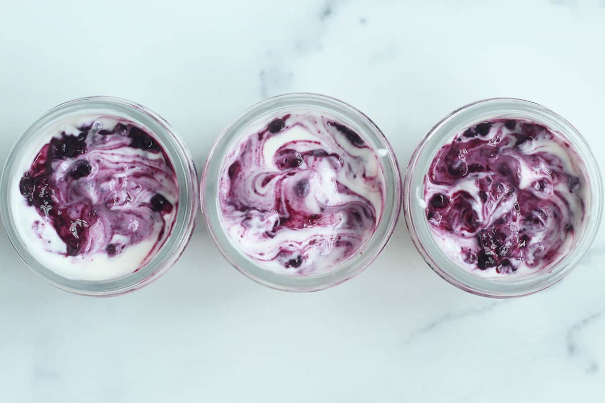 Blueberry yogurt in three jars from above