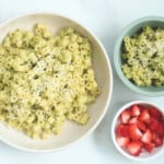 Zucchini pasta on counter in two bowls with side of strawberries