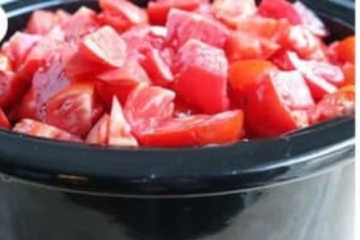 Chopped tomatoes in slow cooker for tomato sauce. 