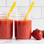 Strawberry juice in mason jars with yellow straws