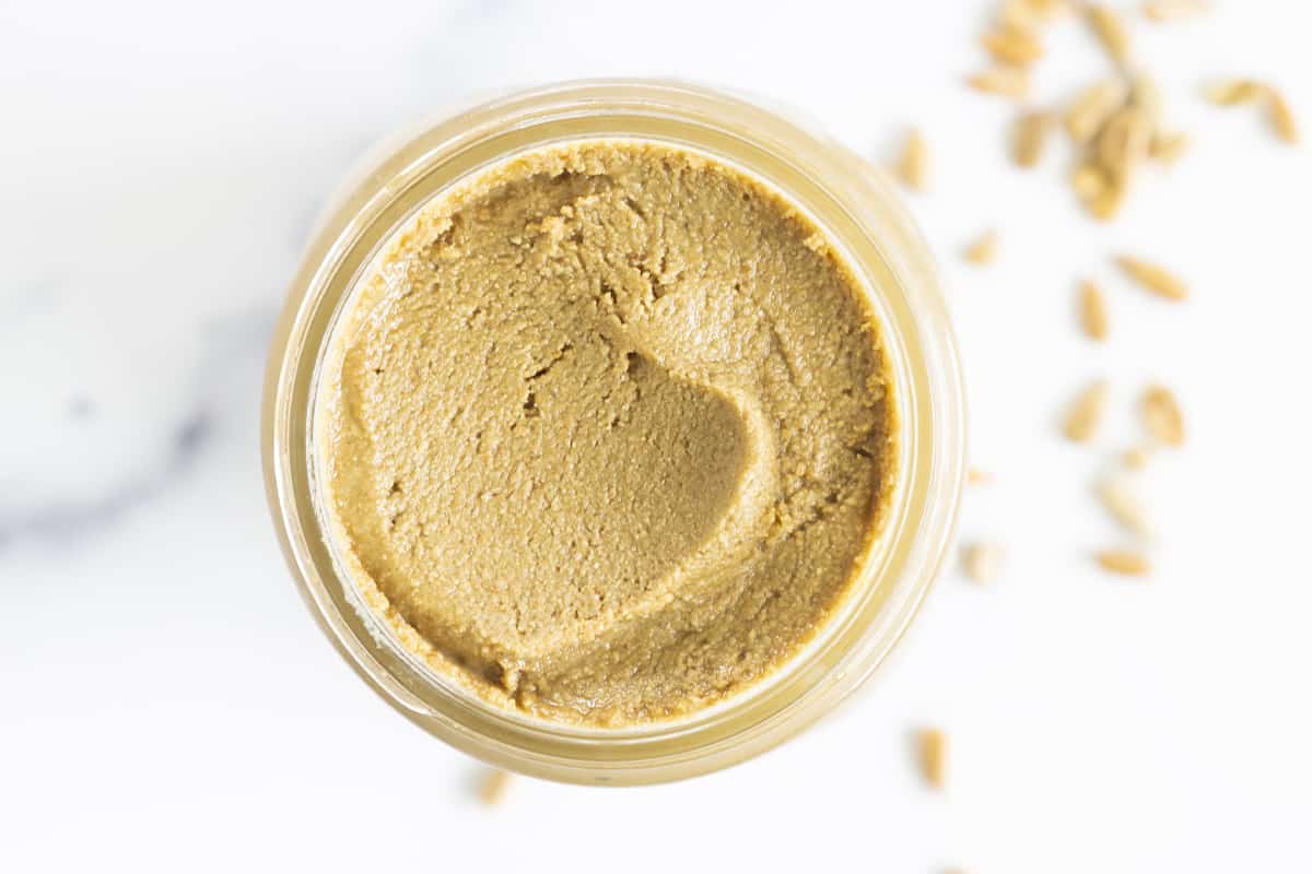 Sunflower seed butter in glass jar from above.