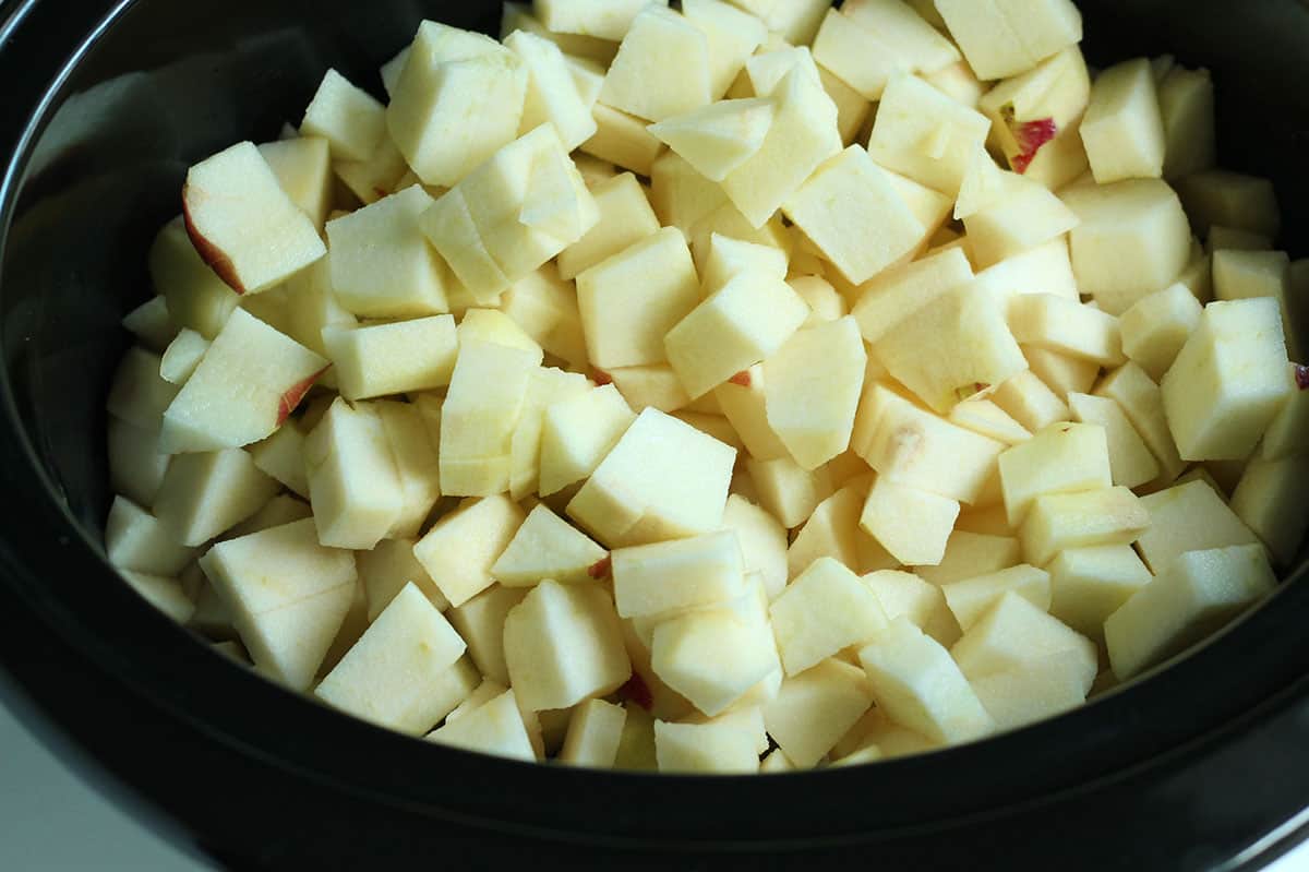 chopped apples in crockpot.