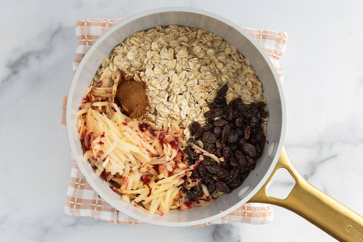 Ingredients for apple cinnamon oatmeal in pot.