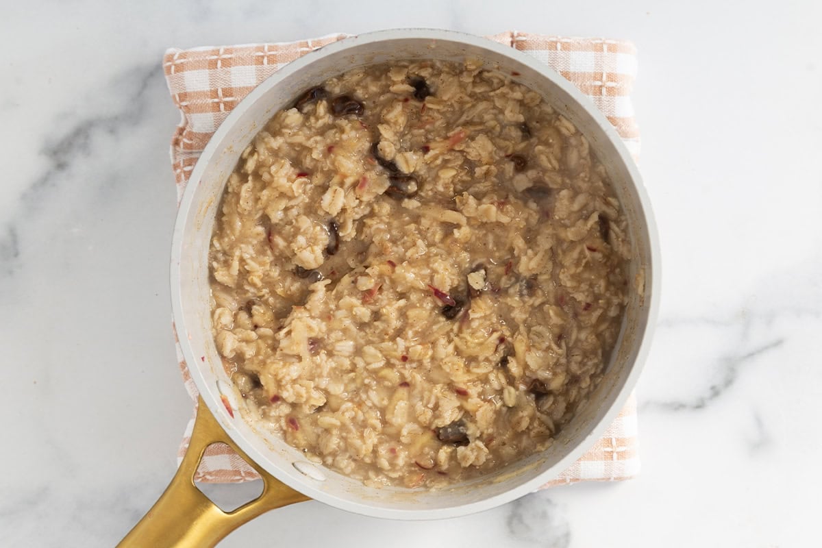 Apple cinnamon oatmeal being cooked in pot.