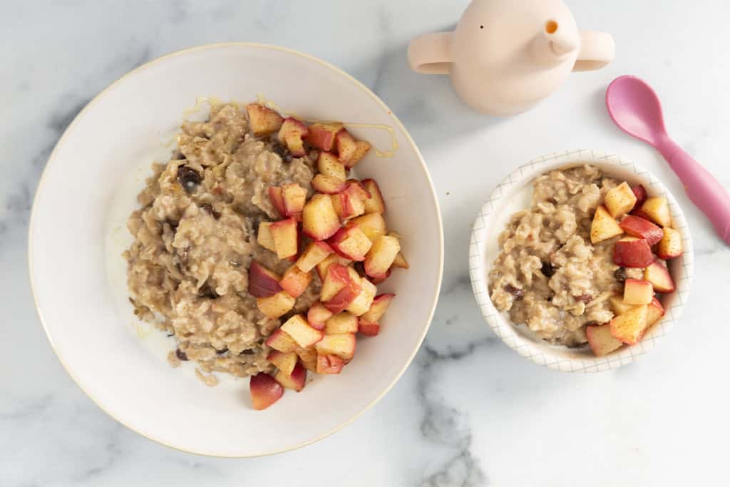 Apple cinnamon oatmeal in two white bowls.
