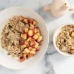 Apple cinnamon oatmeal in two white bowls.
