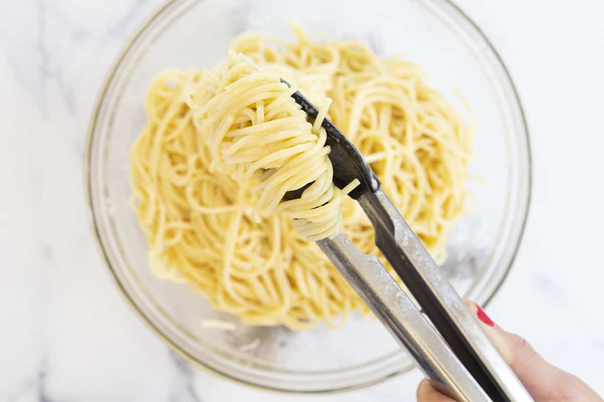 Making buttered noodles in glass bowl.