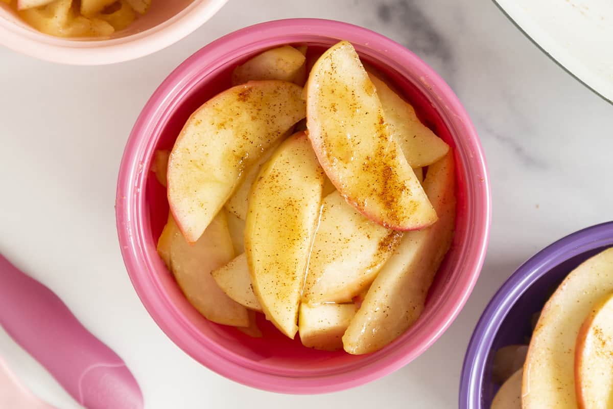 Cinnamon apples in pink bowl.